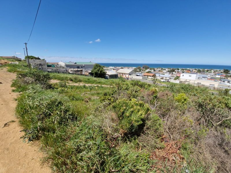 A view of the vacant residential land overlooking the surrounding neighborhood and the ocean coastline.