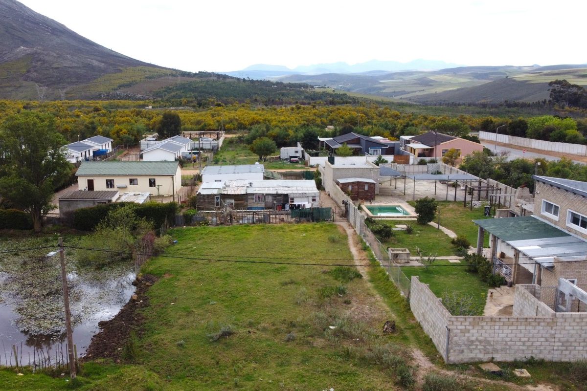 Aerial view of a residential property featuring a swimming pool, garden area, and surrounding neighborhood landscape.