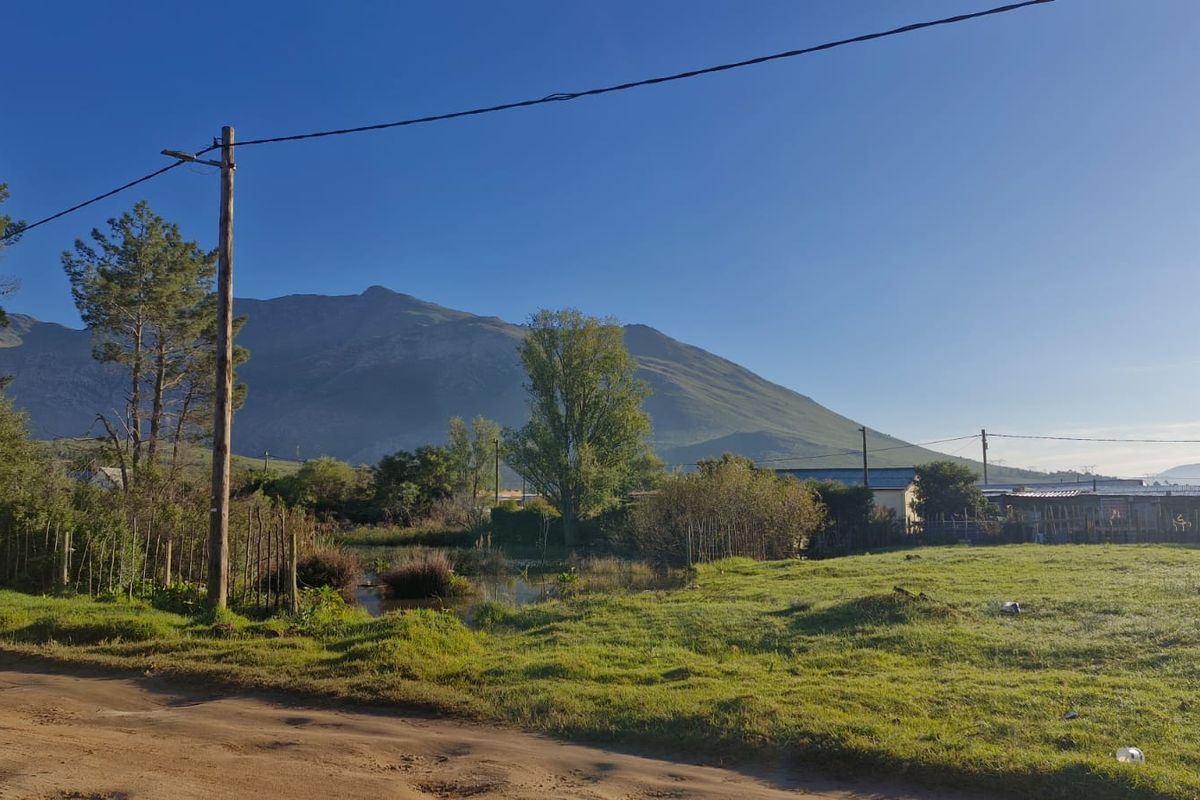 A scenic view of the surrounding landscape and mountain range from the vacant residential property.