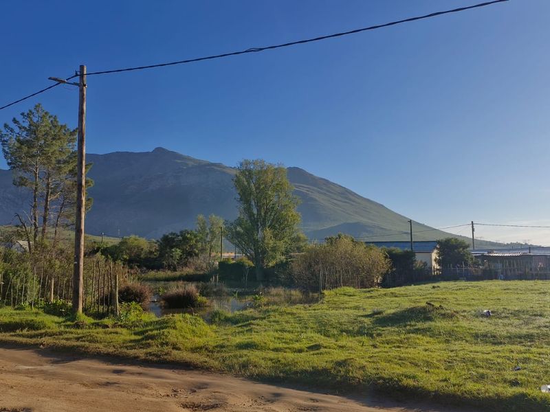 A scenic view of the surrounding landscape and mountain range from the vacant residential property.