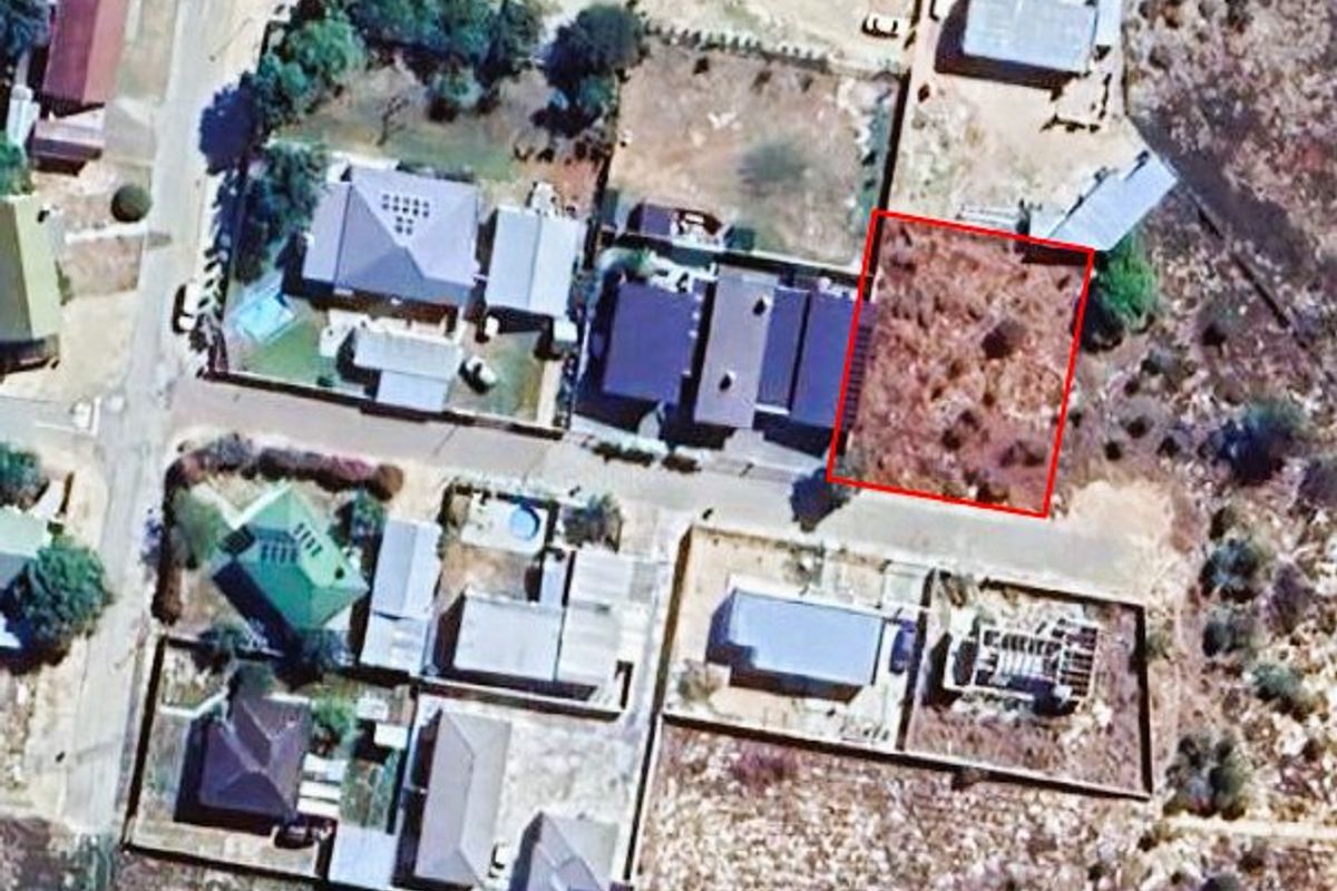 An aerial view highlighting a vacant residential land parcel within an established suburban neighborhood.