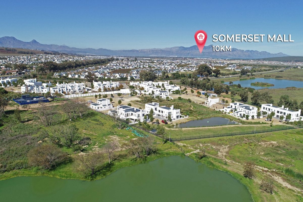 Aerial view of a residential estate development featuring natural ponds, landscaped surroundings, and proximity to local amenities.