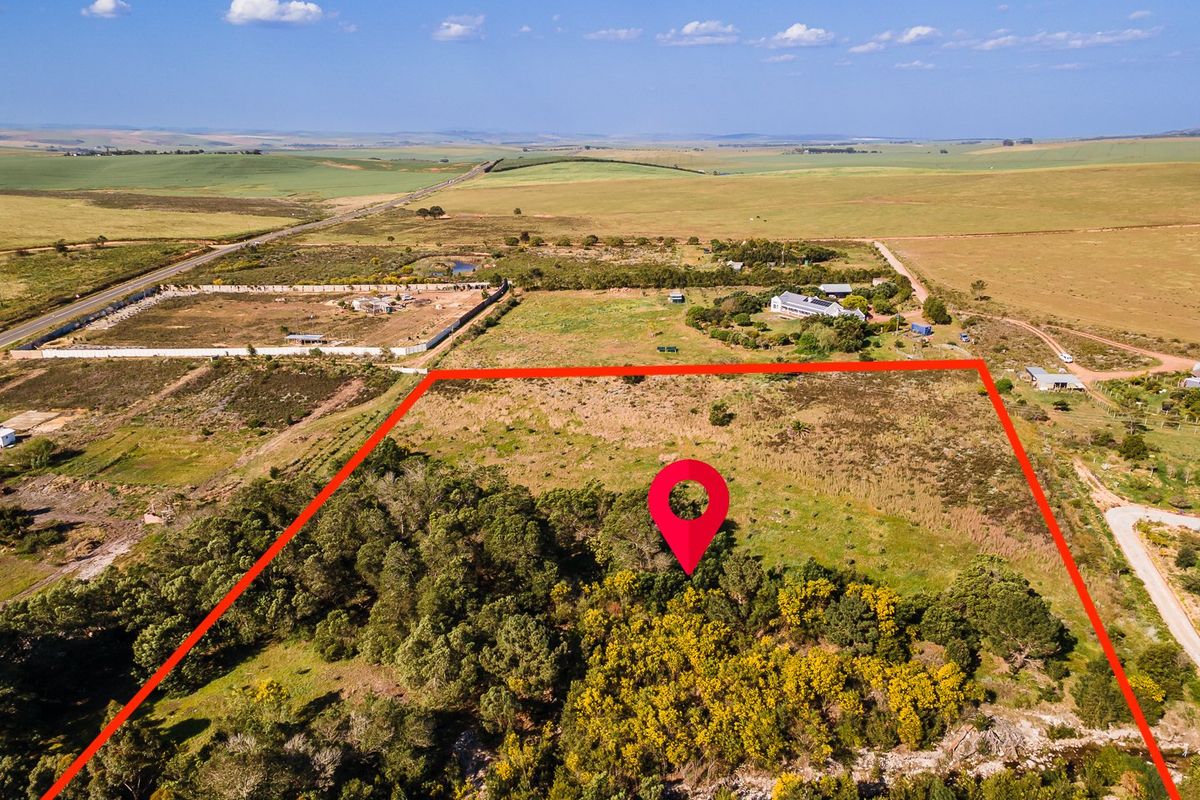 Aerial view of a large, undeveloped residential plot featuring native vegetation and clear boundary lines in a rural landscape setting.