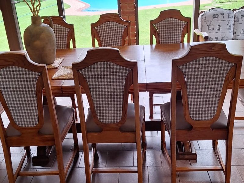 Covered patio area featuring tiled flooring and large sliding glass doors providing a view of the garden and swimming pool.