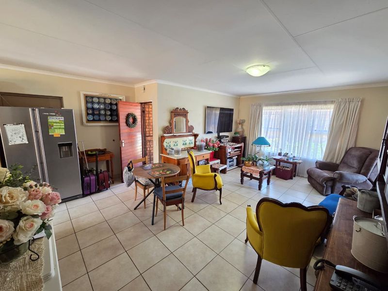 An open-plan living and dining area featuring neutral tiled flooring and standard ceiling finishes, offering a functional and versatile layout for daily living.