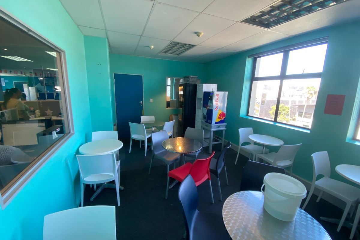A commercial break-out or seating area featuring large windows, suspended ceilings, and bright wall finishes, suitable for office or communal use.