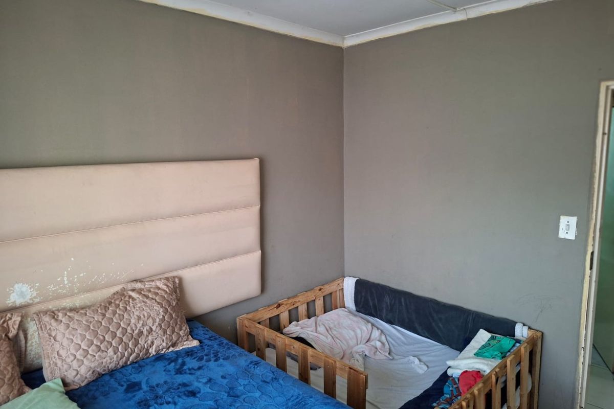 A bedroom featuring neutral wall tones, coving, and standard electrical fixtures, requiring minor cosmetic updates to improve the overall finish.