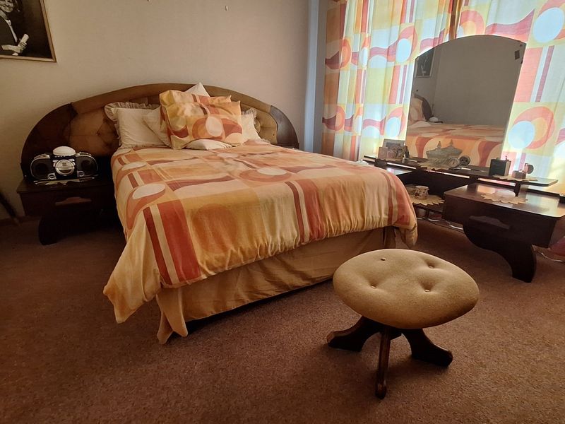 A bedroom featuring fitted carpeting and window treatments, offering a blank canvas for modernization and updated interior finishes.