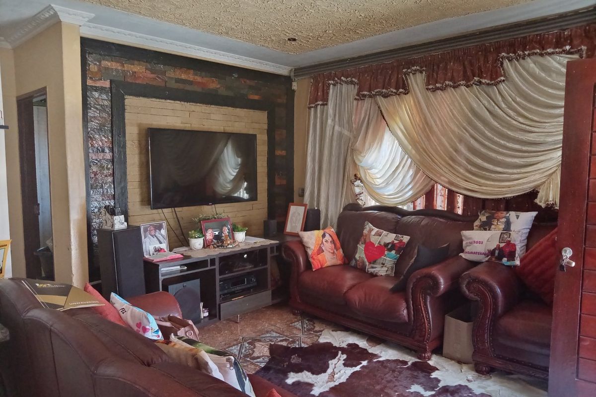 A living room featuring a textured ceiling, stone accent wall, and tiled flooring, providing a functional space for relaxation.