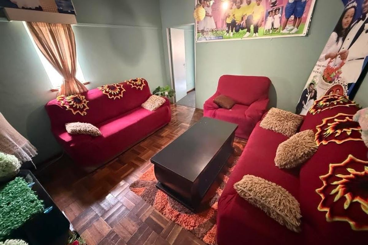 A living room featuring traditional parquet flooring and a standard layout, offering a functional space for relaxation.