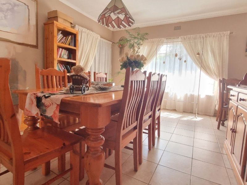 A traditional dining room featuring tiled flooring and built-in wooden cabinetry, offering a functional space for family meals.