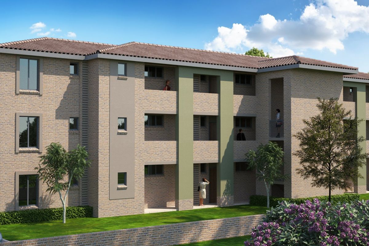 A modern multi-story apartment building featuring a brick facade, tiled roof, and integrated balconies set within a landscaped residential complex.