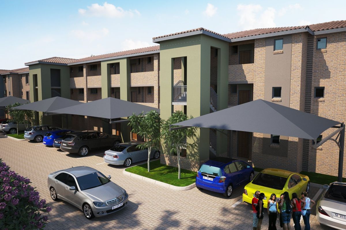 A modern apartment complex featuring a brick facade, tiled roofing, and dedicated covered parking bays for residents.