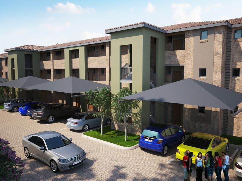 A modern apartment complex featuring a brick facade, tiled roofing, and dedicated covered parking bays for residents.