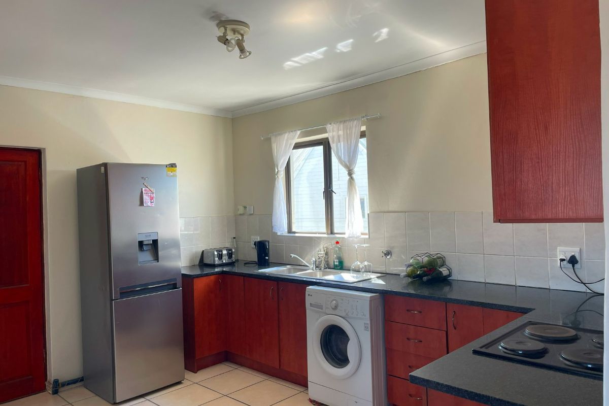 Spacious Top-Floor Retreat with Private Garage, Braai Balcony & Secure Living in Manhattan Park Complex - Photo 5