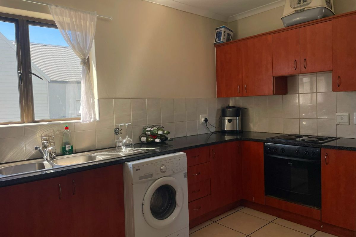 Spacious Top-Floor Retreat with Private Garage, Braai Balcony & Secure Living in Manhattan Park Complex - Photo 3