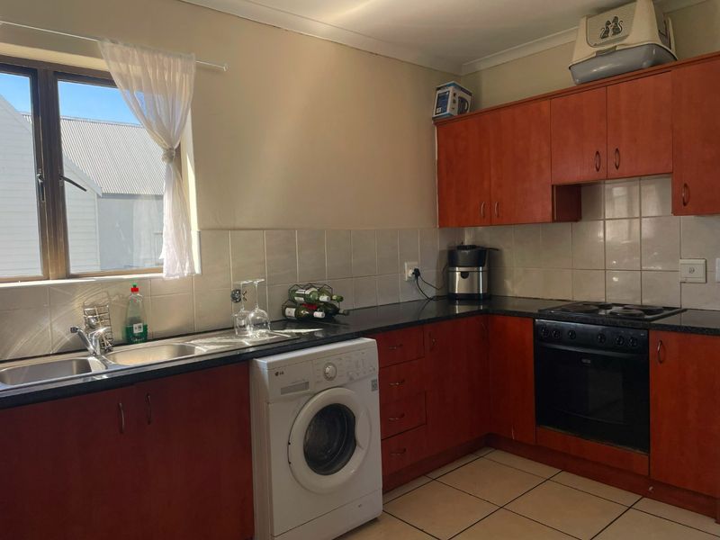 Spacious Top-Floor Retreat with Private Garage, Braai Balcony & Secure Living in Manhattan Park Complex - Photo 3