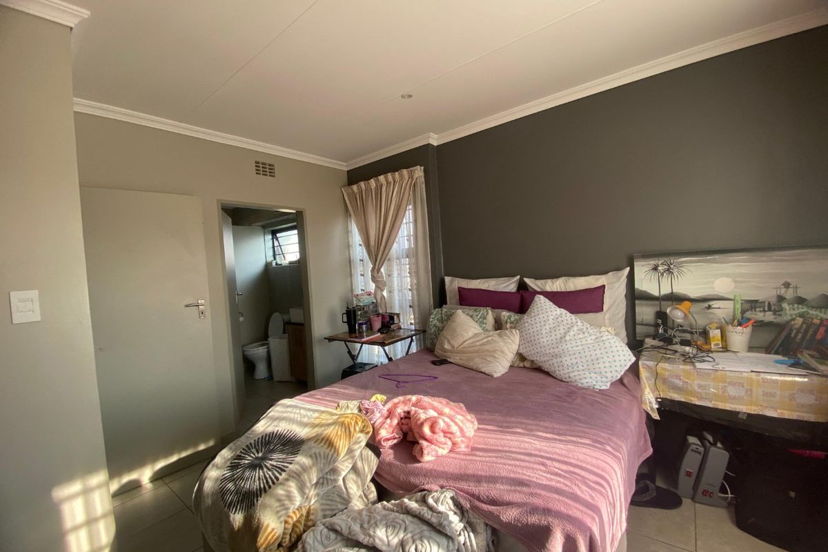 A bedroom featuring tiled flooring, recessed ceiling lighting, and direct access to an en-suite bathroom.