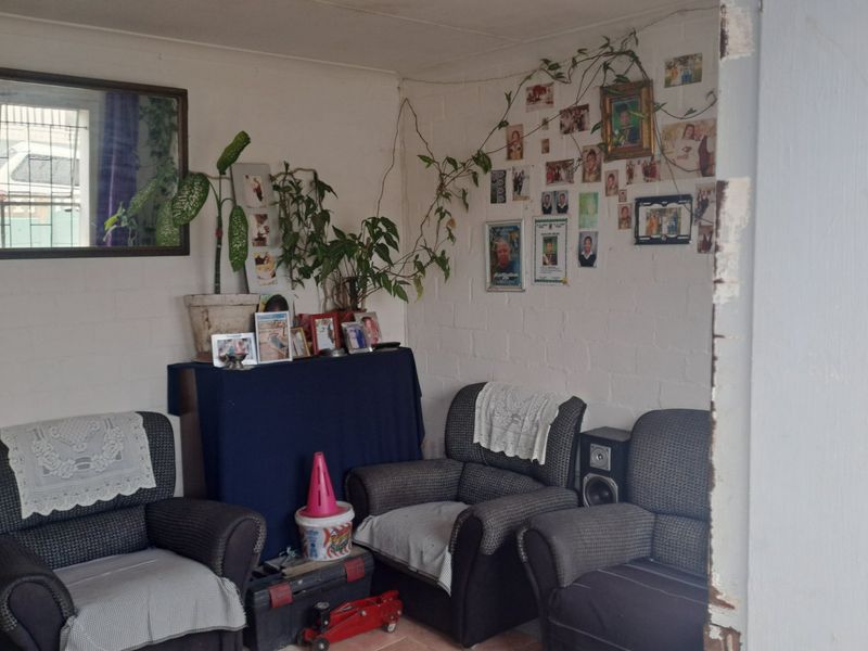 A living area featuring painted brick walls and tiled flooring, requiring cosmetic updates to improve the overall aesthetic and finish.