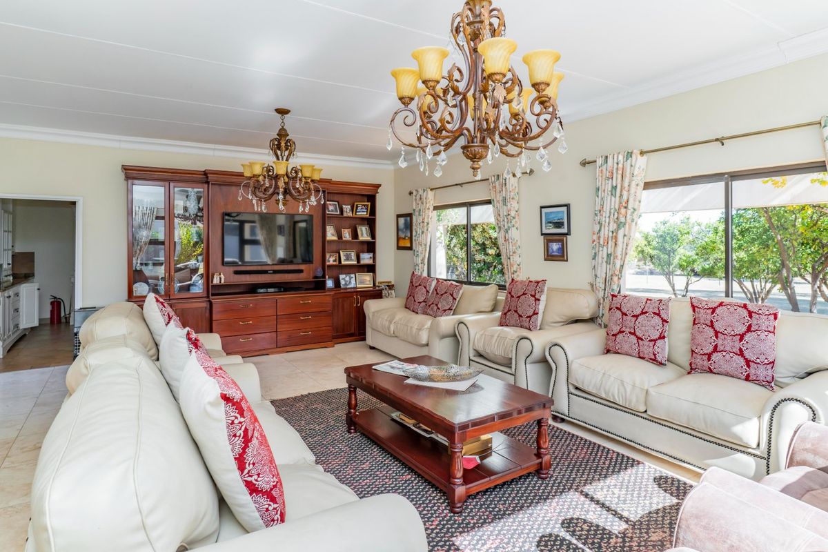 Spacious living room featuring built-in wooden cabinetry, tiled flooring, and large sliding glass doors that provide ample natural light.