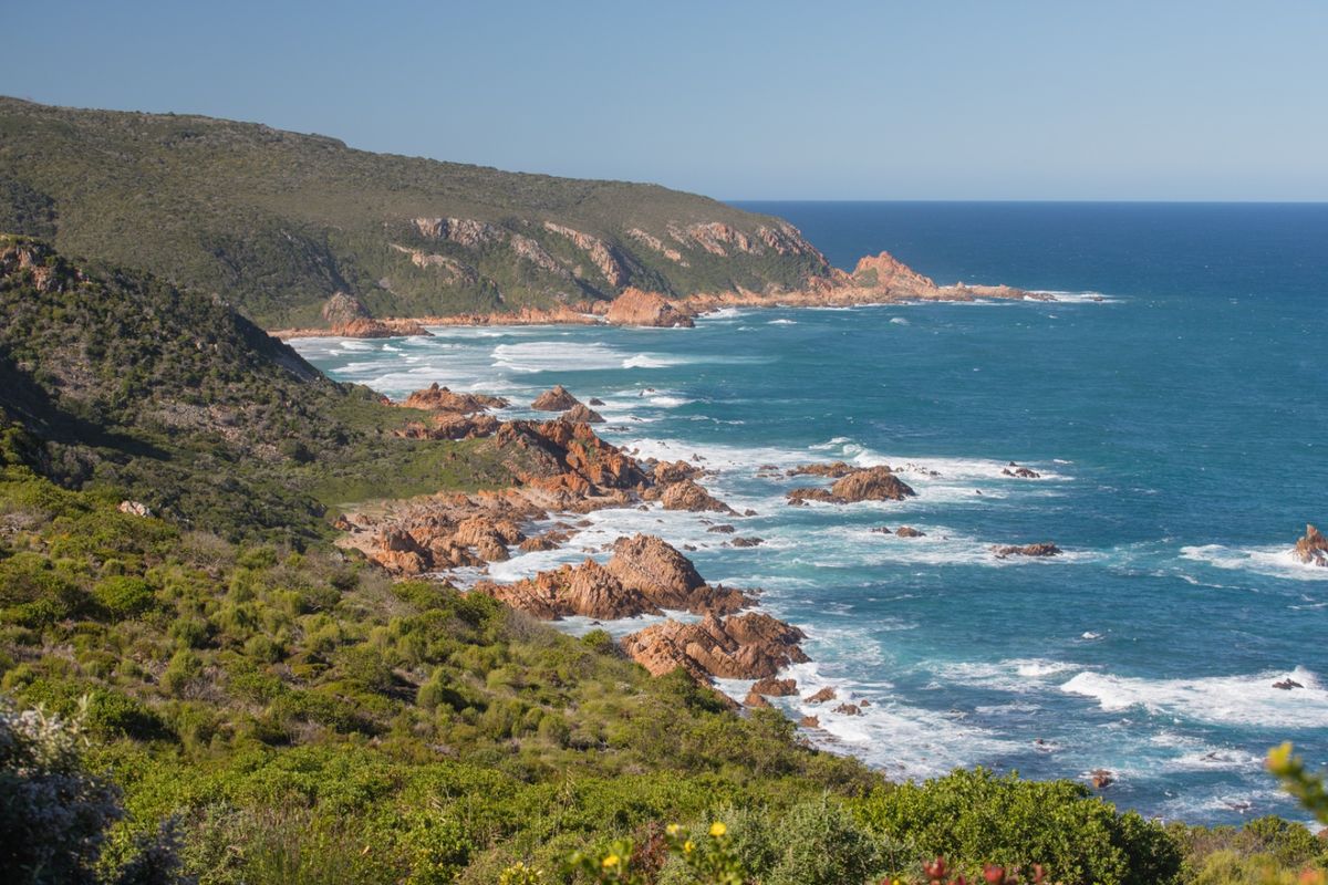 A scenic coastal view showcasing the rugged shoreline, rocky outcrops, and expansive ocean horizon.