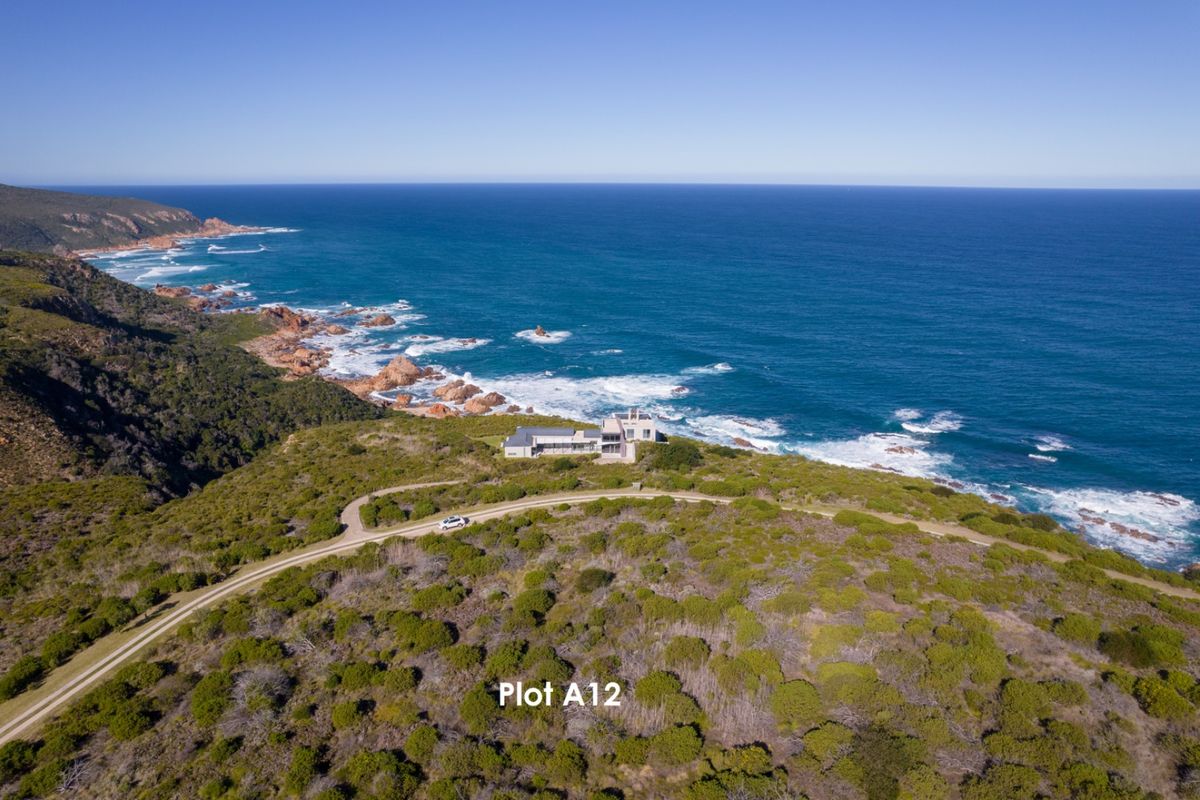 Aerial view of vacant residential plot A12, featuring expansive coastal views and natural vegetation.
