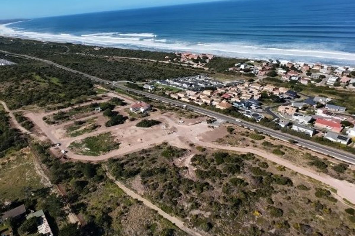 Aerial view of a coastal development site showing proximity to the ocean and surrounding residential neighborhood.