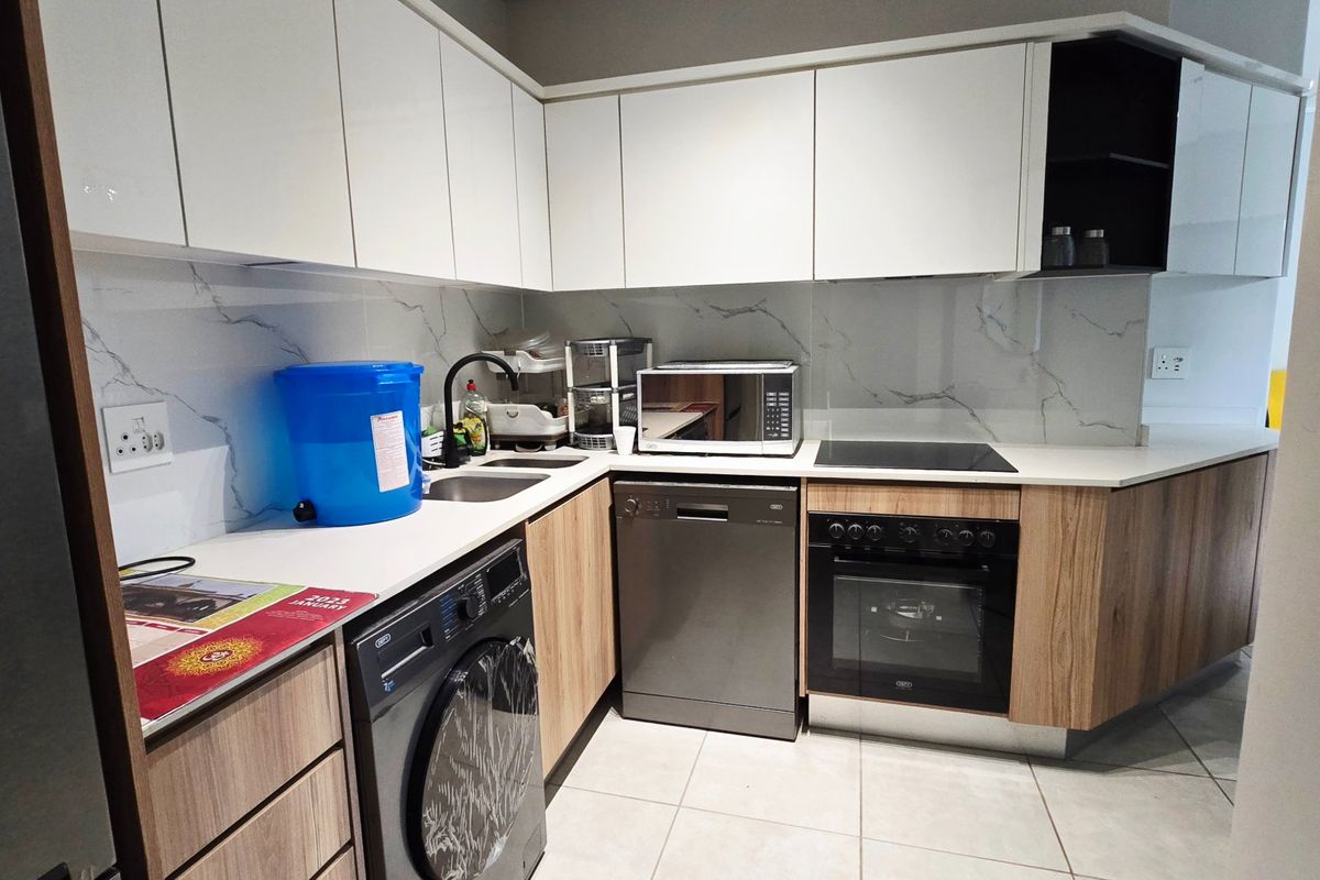 Modern kitchen featuring white gloss cabinetry, wood-grain lower cupboards, marble-look splashback, built-in oven, electric hob, and integrated dishwasher.
