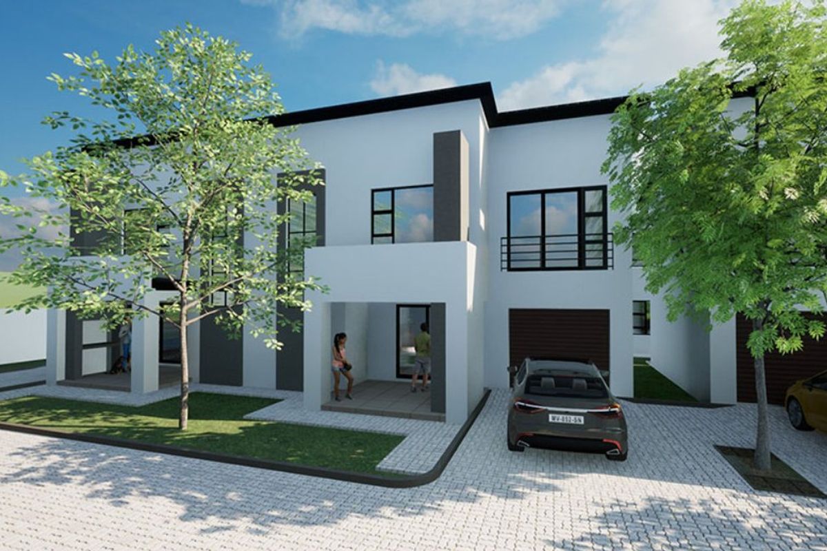 A modern townhouse exterior featuring a clean architectural design, paved driveway, and covered entrance.