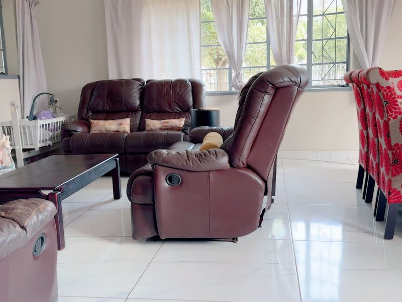 Spacious open-plan living and dining area featuring polished tiled flooring and large windows that provide ample natural light.