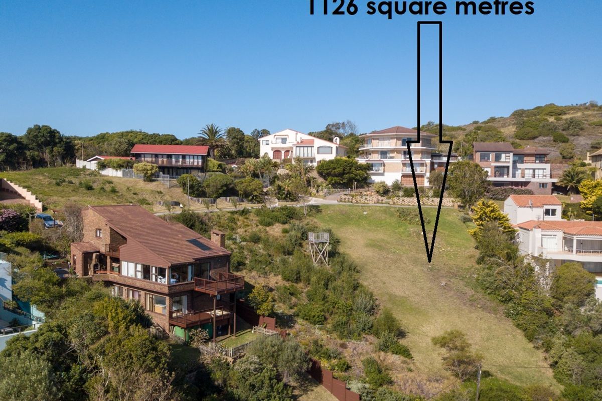 An aerial view of a vacant residential plot measuring 1126 square metres, situated within an established hillside neighborhood.