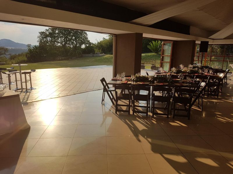 Spacious covered patio area with large sliding doors, seamless indoor-outdoor flow, and expansive views of the surrounding landscape.