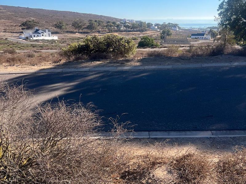 A view of the surrounding coastal landscape and residential area from the vacant land plot.
