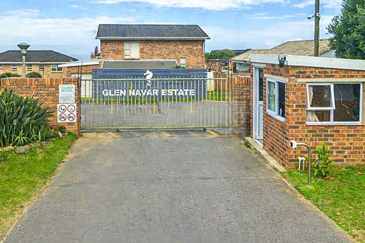 The entrance to Glen Navar Estate featuring a secure gated access point, brick guardhouse, and paved driveway.