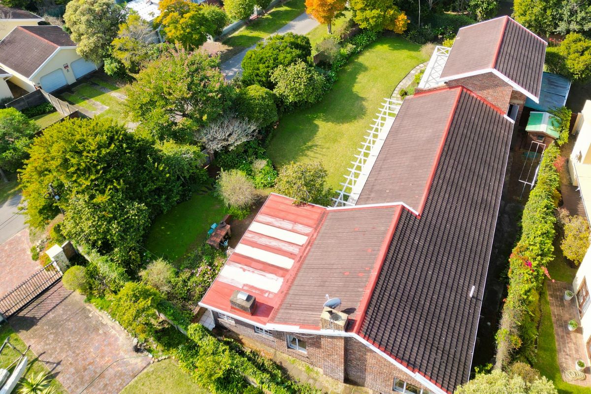 Aerial view of the property showcasing the roof structure, surrounding garden, and established landscaping.