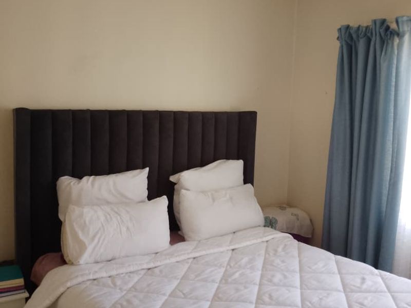 A standard bedroom featuring neutral wall finishes and coving, providing a functional space for rest.