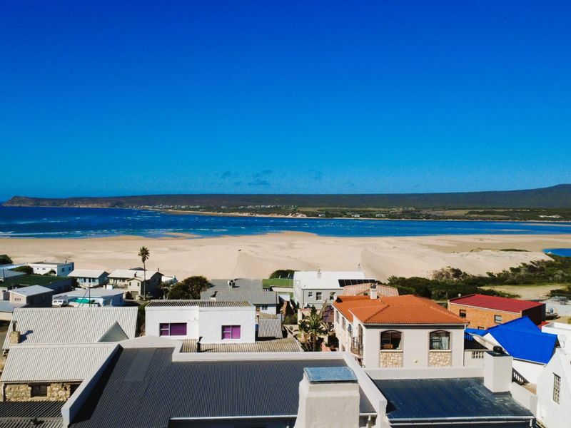 An aerial view showcasing the coastal residential area with direct proximity to the beach and ocean.