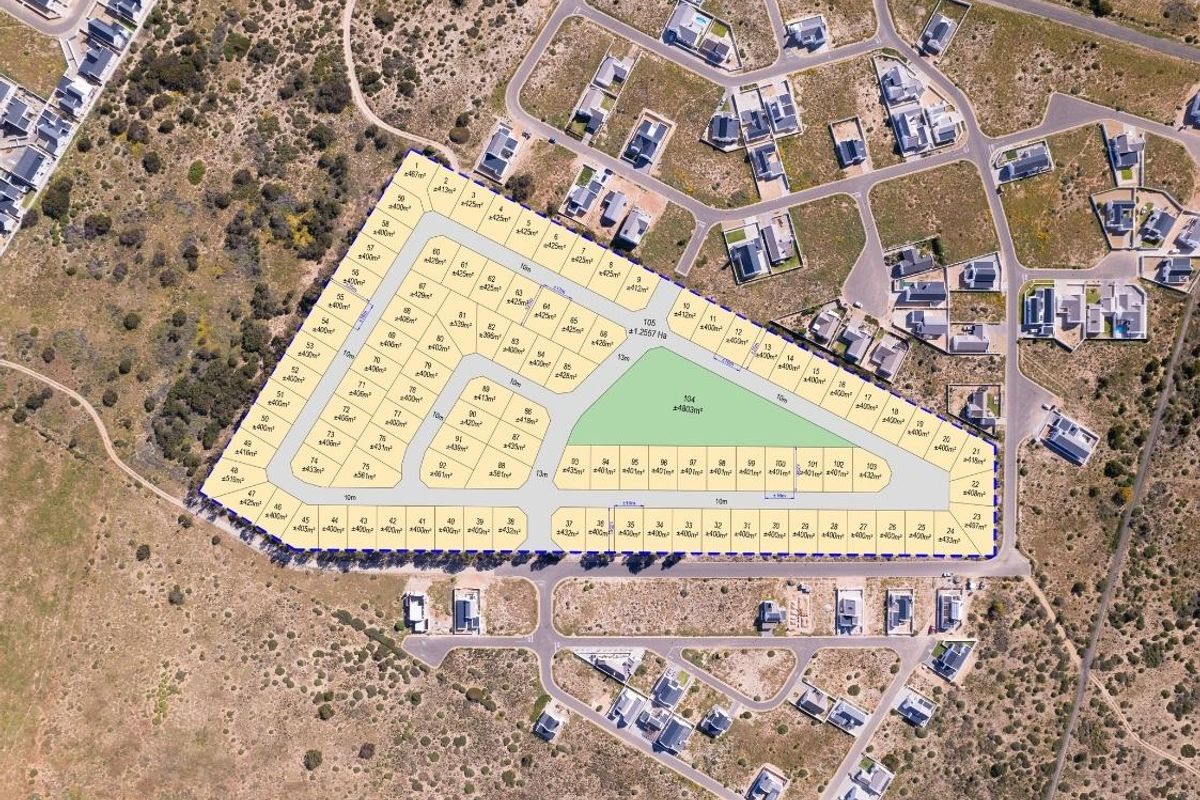 An aerial view showing the layout and subdivision of a residential land development project with multiple plots and internal road access.