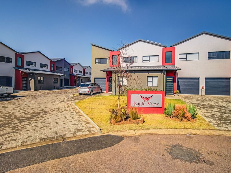 Front view of the Eagle View residential complex featuring modern multi-story townhouses with paved driveways and integrated garages.