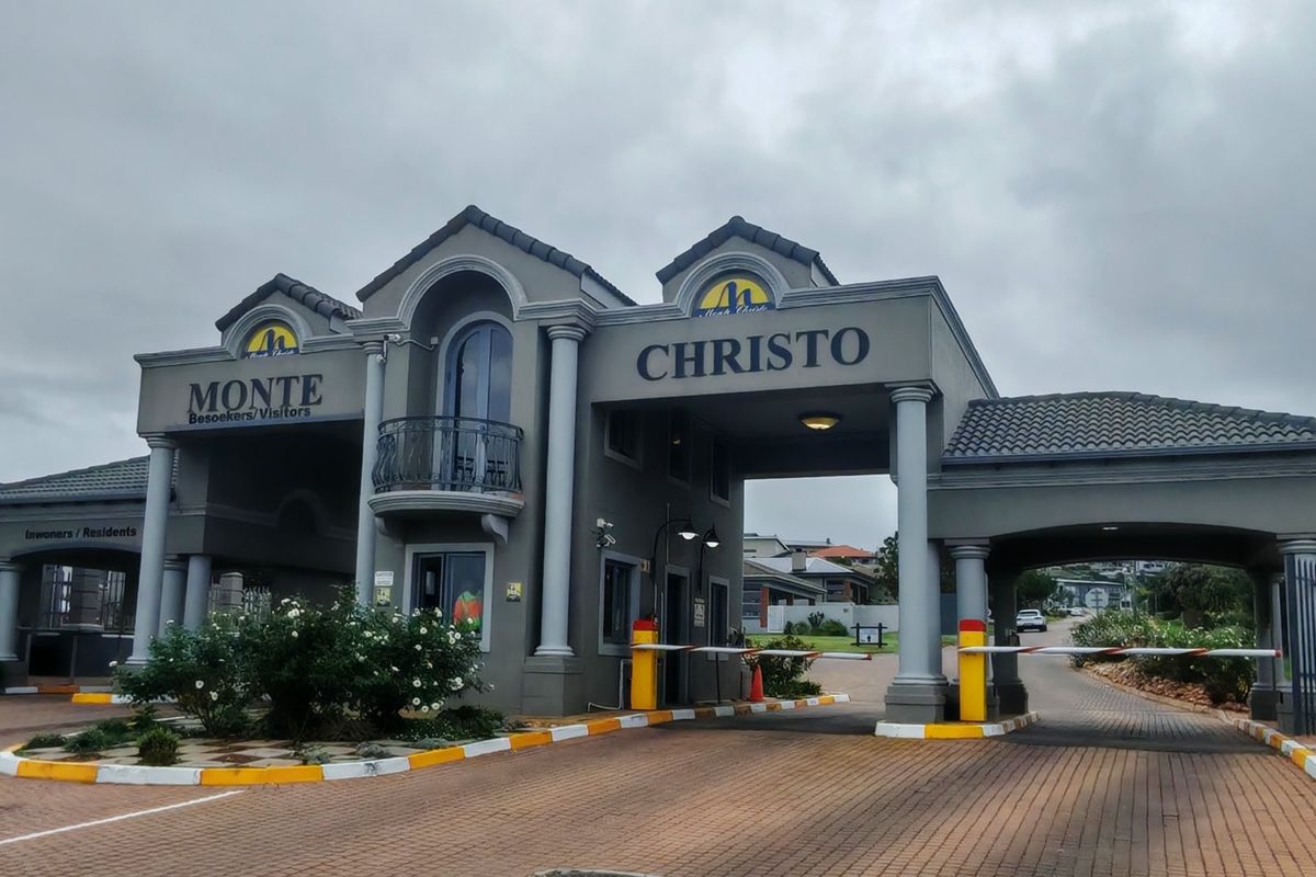 The main entrance gatehouse of the Monte Christo estate, featuring a secure boom gate system and architectural columns.