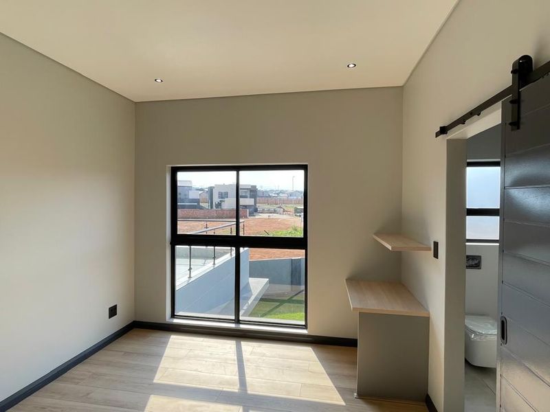 Contemporary 4 Bedroom Family Home | Covered Patio with Braai | Pool | Double Garage - Photo 10