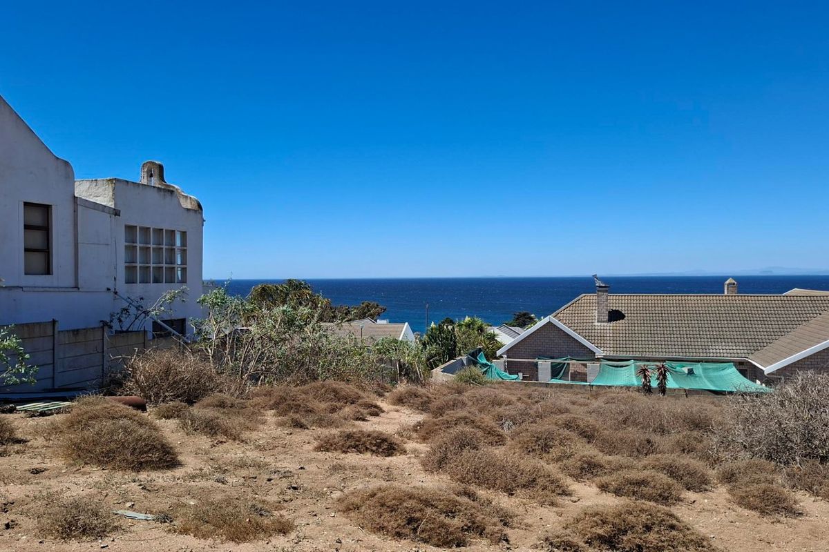 A scenic view of the ocean from the vacant residential land, showcasing the coastal landscape and surrounding neighborhood properties.
