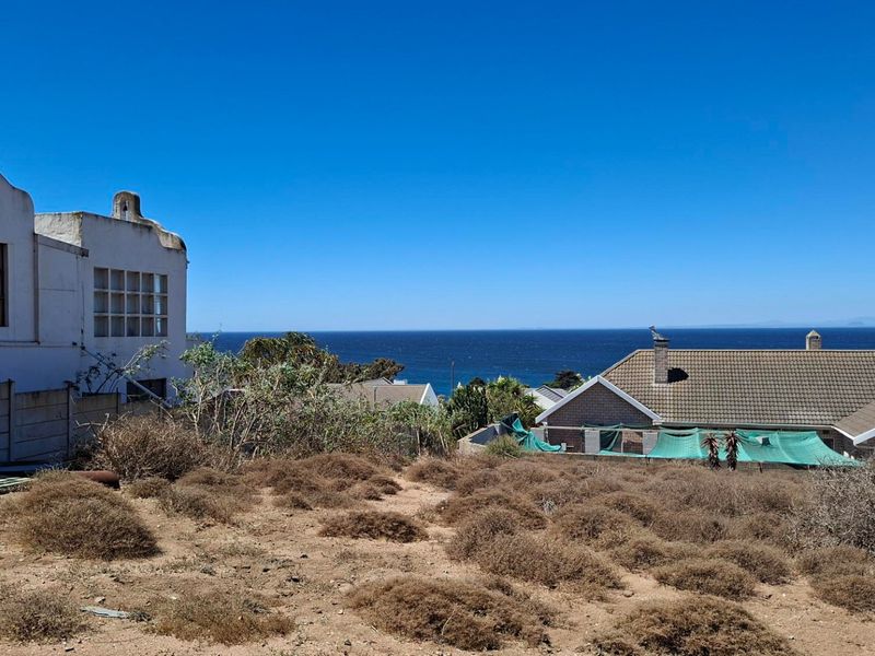 A scenic view of the ocean from the vacant residential land, showcasing the coastal landscape and surrounding neighborhood properties.
