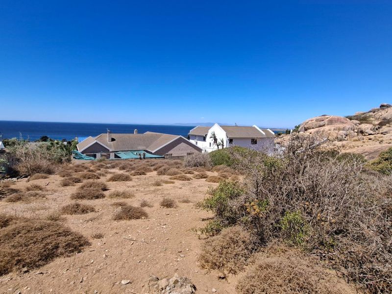 A view of the coastal landscape and surrounding residential properties from the vacant residential land.