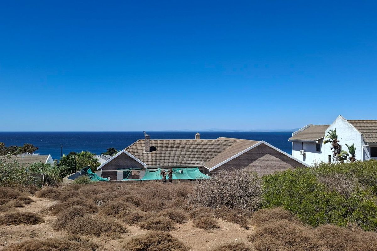 A scenic elevated view overlooking the ocean and surrounding coastal residential properties.