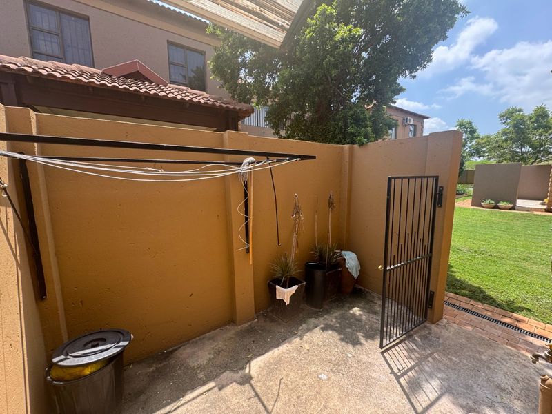 This charming 3-bedroom, 2.5-bathroom townhouse is situated in a secure estate, offering both comfort and privacy. - Photo 4