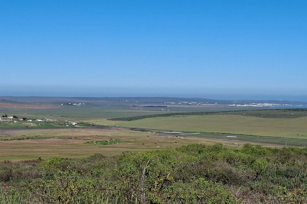 Expansive panoramic view of the surrounding rural landscape and open fields, showcasing the natural terrain of the vacant land.