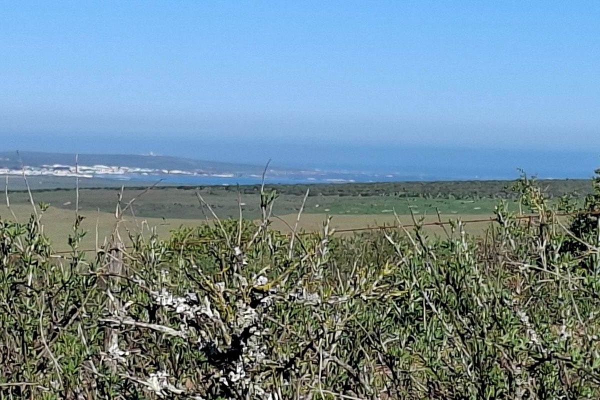 A scenic view of the surrounding landscape and distant coastline from the vacant residential property.