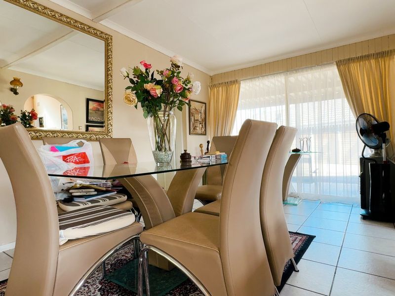 A dining room featuring tiled flooring and a sliding glass door providing access to the outdoor area.