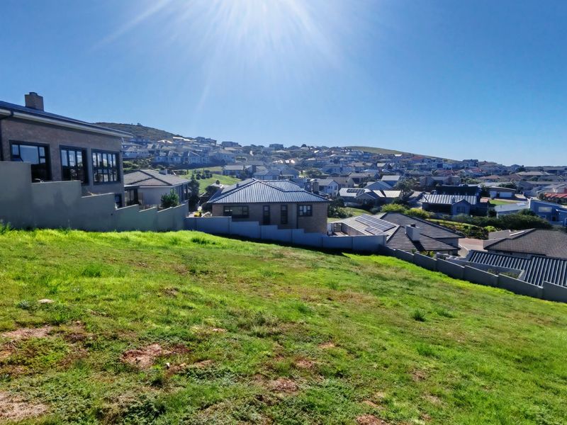 A view of the surrounding residential neighborhood from the elevated, sloped vacant residential land.